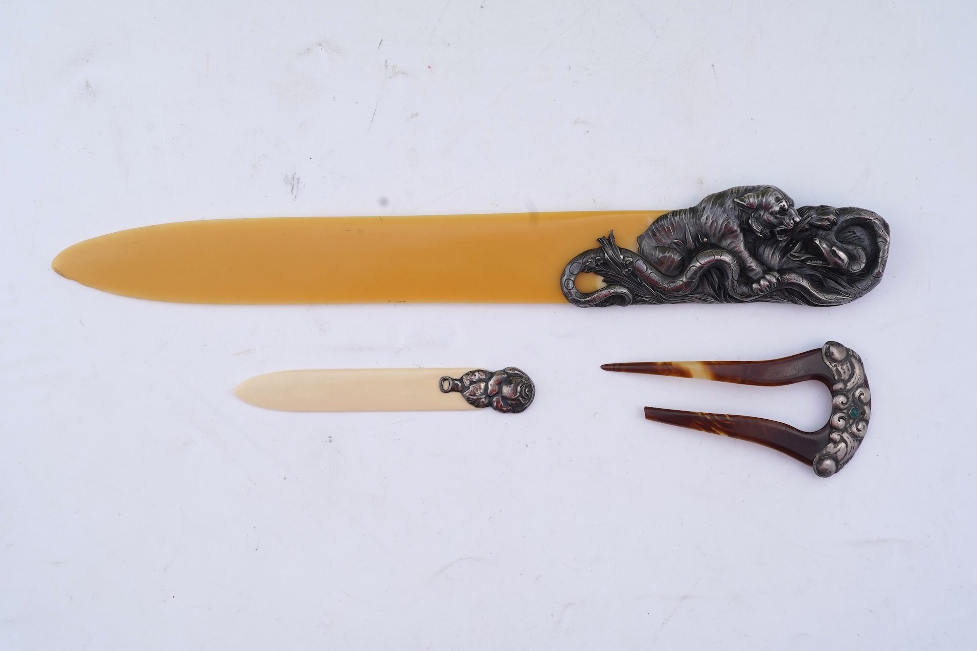 Two paper knives and a hair ornament, early 20th century